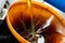 Closeup of motor oil pouring into a large orange funnel