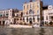 Closeup of motorboats with people and historical buildings of Grand Canal