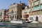 Closeup of motorboats with people and historical buildings of Grand Canal