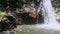 Closeup mountain river waterfall falls into lake among rocks