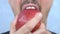 Closeup mouth. a mustached man bites a large red Apple