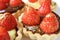 Closeup mouthwatering fresh strawberry tarts with edible gold powder