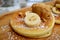 Closeup mouthwatering pancake with fresh banana and caramel ice cream on the wooden plate