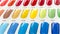 Closeup of a nail color display chart with various vibrant choices with a numbered code. At a nail salon or spa