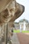 Closeup naked satyr smiling statue crop with fountain and garden