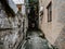 Closeup of a narrow alley between dilapidated houses