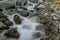 Closeup natural waterfall oasis with stones background