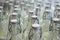 A closeup of the neck of a bottle. Group of empty bottles with plastic caps in a store on the counter.