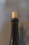 a closeup of the neck of a wine bottle closed with cork background