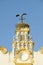 Closeup of nesting European storks on white cathedral tower with beautiful sunlight in village of Southern Spain off highway A49