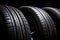 Closeup new car tires for sale at tyre store. Balck rubber car tire with modern tread at auto repair shop. Winter tires at auto