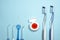 Closeup of new plastic toothbrushes, dental floss and oral irrigator on a blue background.