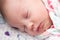 Closeup of a newborn baby sleeping in the crib,