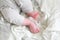 Closeup of newborn legs on a white blanket, childhood and maternity concept. Baby feet