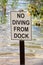 Closeup of a no diving from dock sign