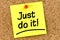 Closeup note on corkboard with just do it message on it