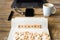 Closeup on notebook over wood table background, focus on wooden blocks with letters making Account word