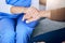 Closeup, nurse and patient holding hands, support and consultation with healthcare, empathy and compassion. Zoom
