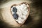 Closeup.oatmeal with prunes in a wooden bowl on the table