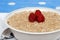 Closeup oatmeal with raspberries focus on berries