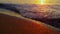 Closeup ocean waves breaking sand beach in slow motion at orange sunset dusk