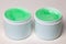 Closeup oft two opened plastic jar or container with green cooling gel horse balm for sports injuries or Aloe vera cosmetic gel