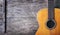 Closeup of old acoustic spanish guitar on rustic wooden background from above