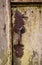 Closeup of the old and classic rusty door latch and lock on wooden door