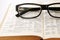 Closeup of old dictionary and glasses