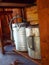 Closeup of old galvanized watering cans under potting bench