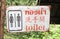 Closeup of old public toilet sign for men and women with translation in three languages thai, chinese and english nature