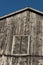 Closeup of old rustic black peeling barn with deep blue sky