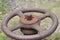 Closeup of an old rusty pressure control valve on a fire hydrant in a field