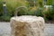 Closeup of an old rusty and weathered metallic faucet on a stone sink filled with water