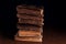 Closeup of old shabby Jewish books in stack in the darkness. Selective focus