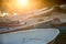 Closeup of old shabby wooden fishing colorful boats and boat bow during a sunset with sun rays