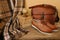 closeup old things, stack of vintage books, globe, shoes, leather military satchel on table, checkered grandmother\\\'s plaid,