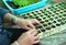 Closeup of old woman`s hands planting vegetable seedling in pla