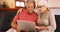 Closeup of older couple using laptop at home