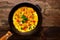 Closeup omelet with old cast iron pan on wooden background with copy space