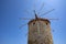 Closeup of One of the Ancient Windmills Against the Blue Sky on Rhodes Harbor