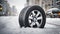 Closeup of one brand new car tire on a snowy winter road displayed