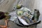 Closeup of one hundred dollar bills of American dollars and a money sack with different coins of the world on a gray wooden table