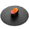 Closeup of one piece of sushi on a black round board isolated on white