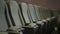 Closeup one Row of Empty Gray Chair in Dark Cinema Hall
