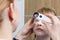 A closeup of an ophthalmologist checking the eye of a child