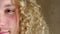 Closeup for optical vision exam of a man with curly blond hair looking for lenses to improve eyesight. Face portrait of