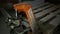 Closeup orange dirty powerful forklift holds wooden pallets