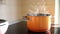 Closeup orange enamel steel cooking pan on modern inductive hob with boiling water or soup and scenic vapor steam