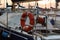 Closeup of Orange Lifebuoy and Rolled Rope on Sailing Boat